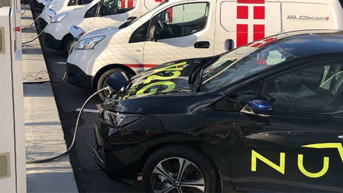 Row of EVs plugged into chargers for vehicle-to-grid testing