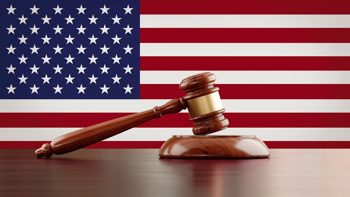 US flag backdrop with a judge’s gavel symbolizing federal regulation and policy decisions.
