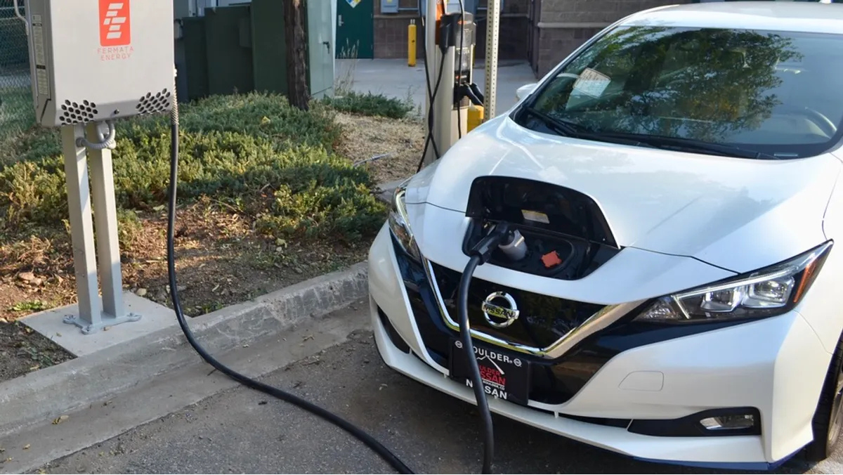 Nissan EV connected to bidirectional charger in vehicle-to-grid pilot