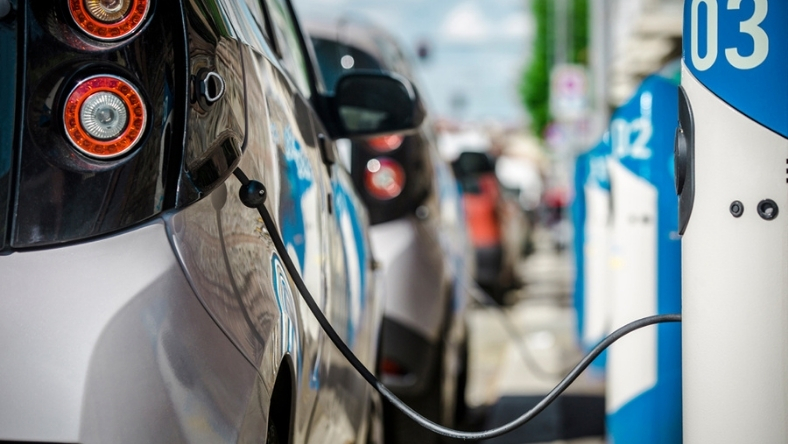 Electric vehicle charging at public station supporting vehicle-to-grid integration